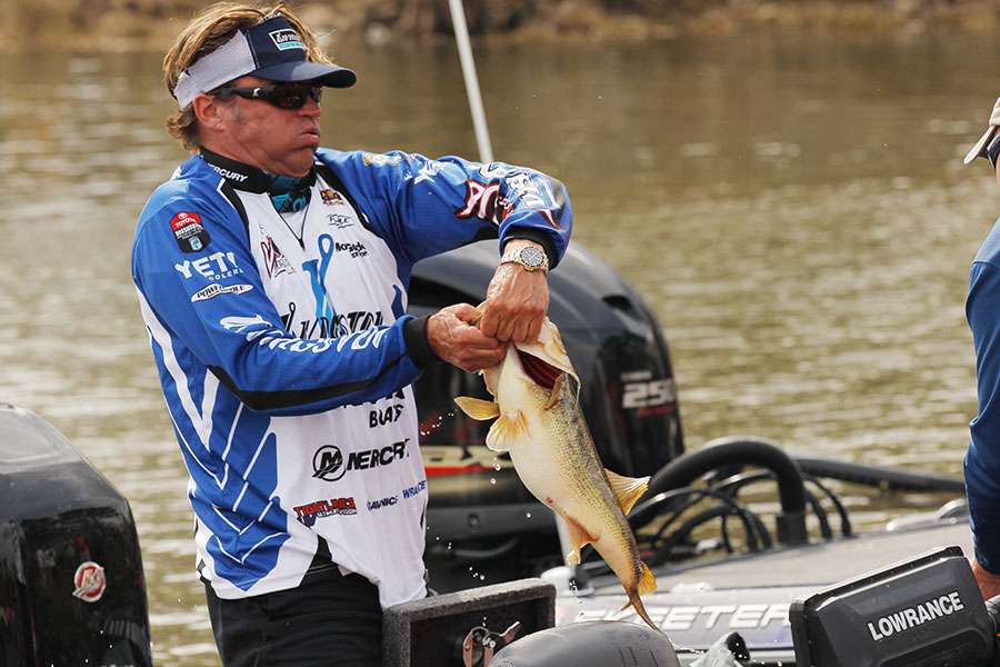 Byron Velvick tries to maintain his grip as he pulls a bass from his livewell.