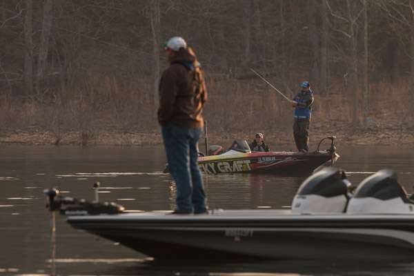 Kelly Jordon is hard at work early on Day 1 as a local angler follows the action.