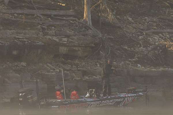 Brandon Palaniuk is struggling today.  As he moves through the shadows, he hooks his first of the day. It was challenging locating the anglers this morning. 