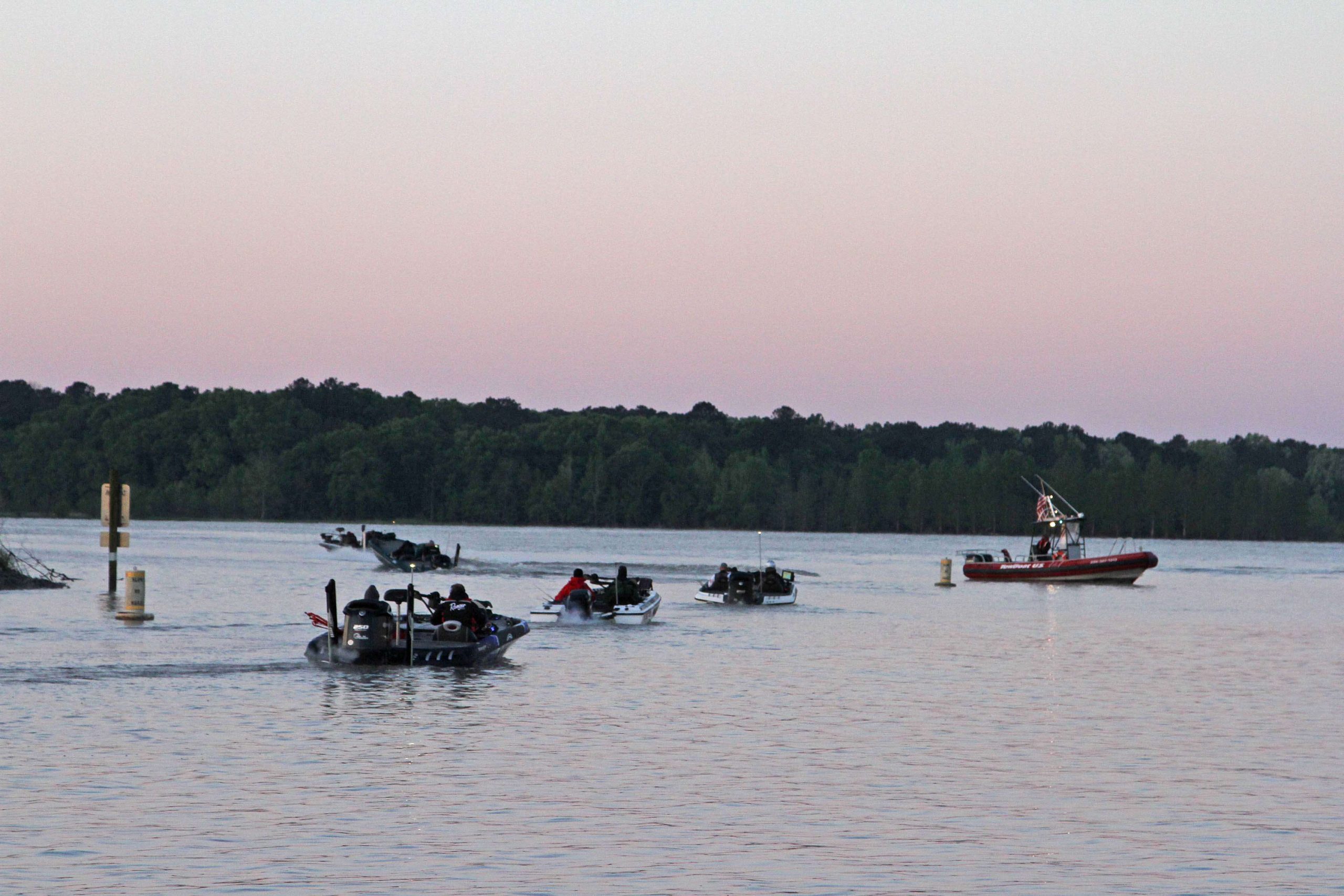 Competitors make their way out of the marina for the start of Day 1.