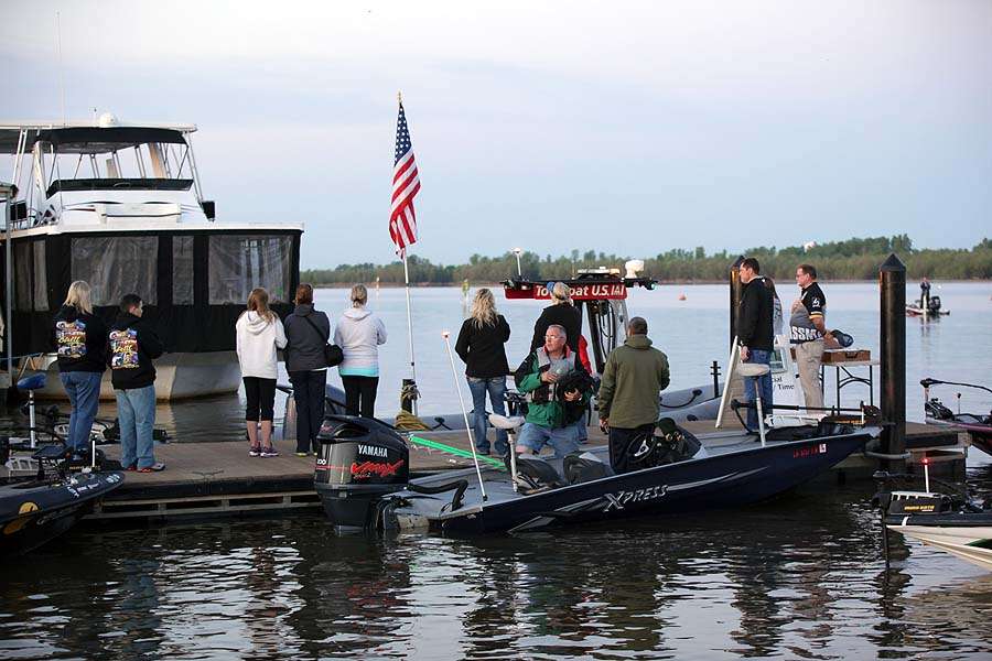 As fans and family members of the anglers do the same toward the flag mounted on the TowBoat U.S.