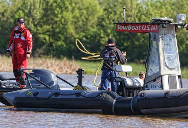 Charlie Murray with TowBoat U.S. secures a rope to Mitchellâs boat. 