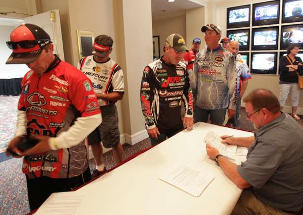 Elite Series anglers present their fishing licenses to B.A.S.S. official Max Leatherwood.