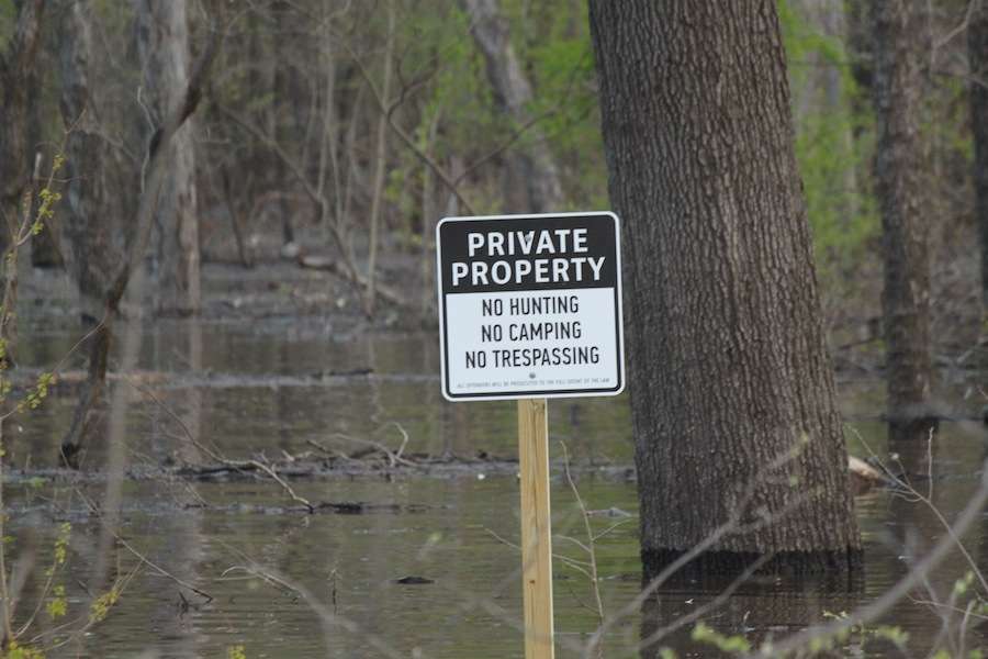 Private property signs are scattered around the land bordering the Ouachita River. 