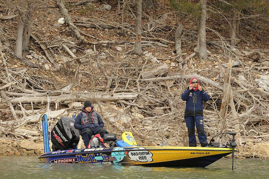 He's re-tieing his lure.