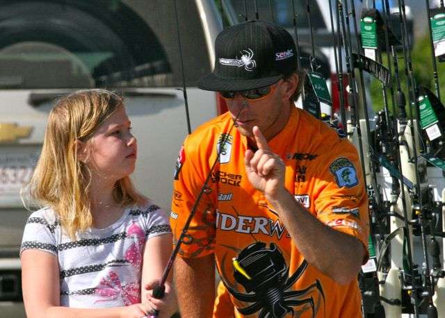 Alexis Lee, 8, of Rogers gives her full attention as Fletcher Shryock provides the No. 1 key to casting.