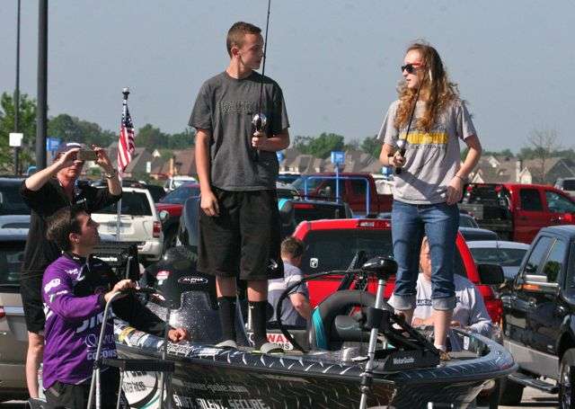 Hunter Butler, 13, and his sister, Taylor, 16, of Gentry discuss some advice given by UA Bass team member Jonny Schultz (lower left) while they practice prior to competition.