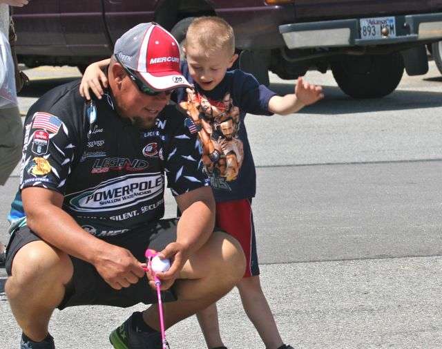 Chris Lane gets some casting tips from his new buddy, 4-year-old Matthew Kitts of Hindsville.