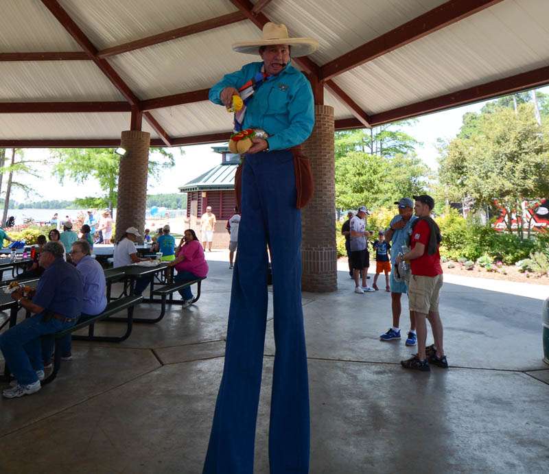 Yes, that's a tall cowboy with a fake hot dog and mustard. 