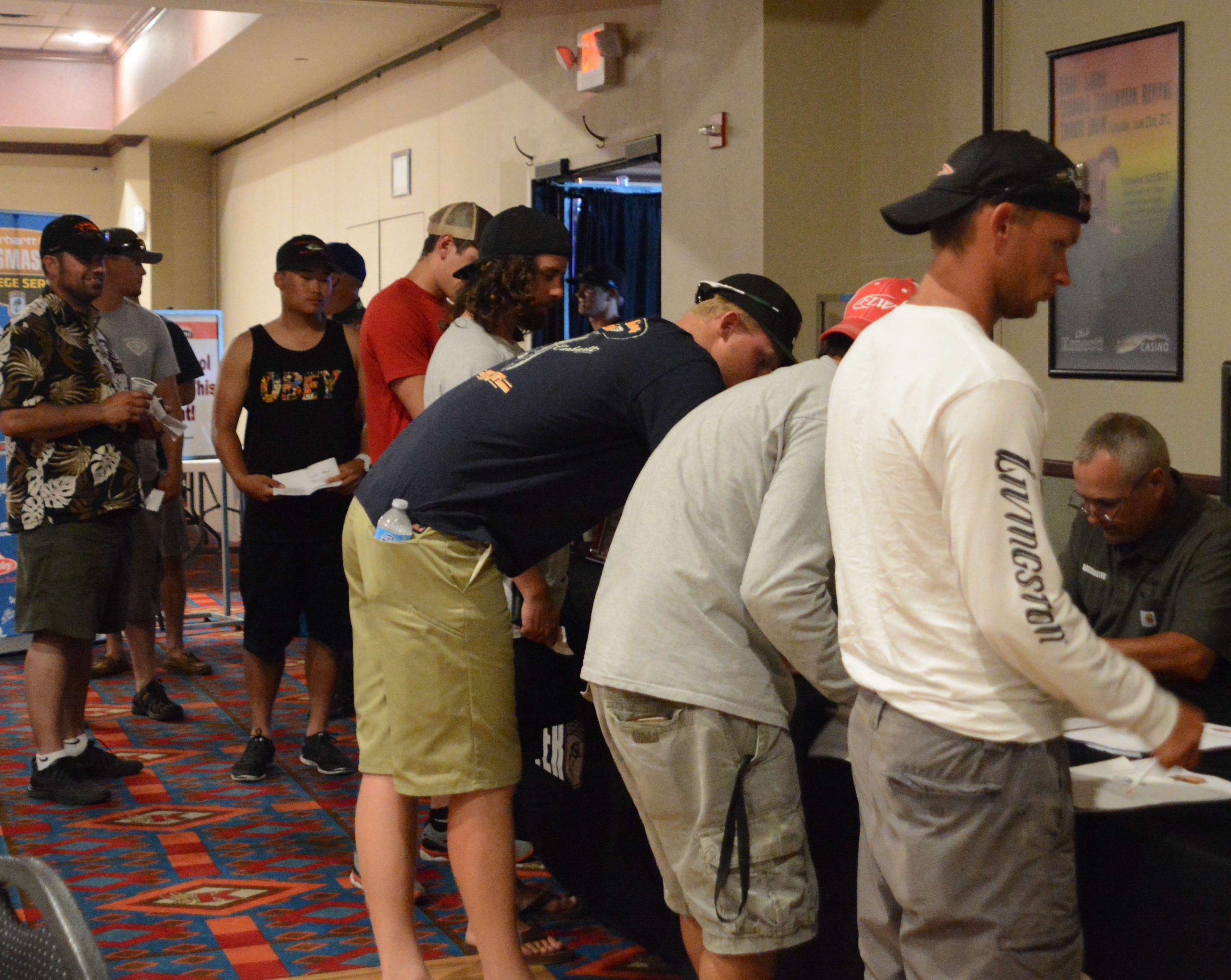 College anglers go through the registration line inside the banquet hall in the casino.