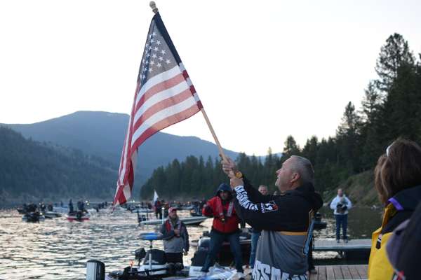Anglers pay tribute during the singing of the national anthem.