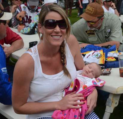 Lisa Bertsch cheers on her husband, Harrison Bertsch, with their two-week-old daughter, Hadley.