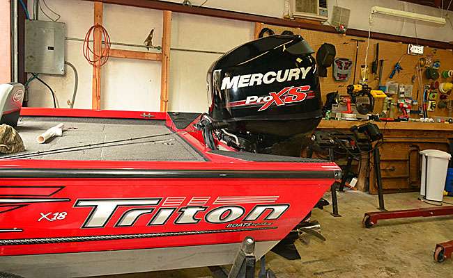 Here's what we're working with, a 2013 Triton X18 aluminum boat with a 115-horse Mercury Optimax ProXS. If you're at all uncomfortable with any of the following steps, do yourself a favor and let  a pro do it. Labor is cheaper than dropping your motor on the pavement, potentially breaking it and your foot, and then having a pro do it anyway.