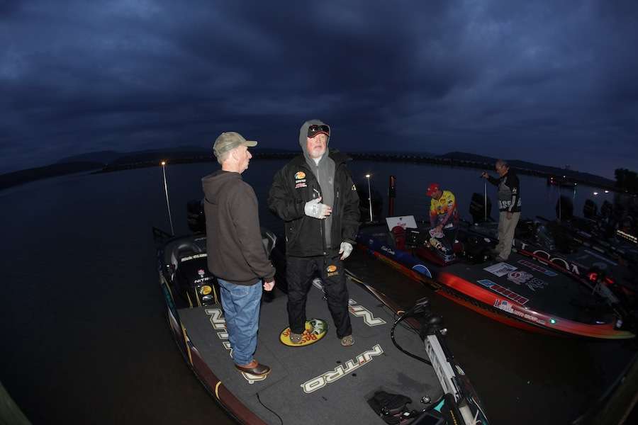 Tournament Director Trip Weldon goes through the boat check with Rick Clunn. 