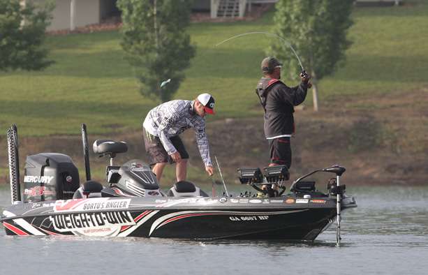 Troy Morrow fires a cast while his Day Two co-angler reaches for another rod. 