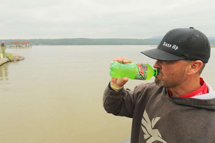 Gerald Swindle drinks Diet Mountain Dew before he bags his fish.