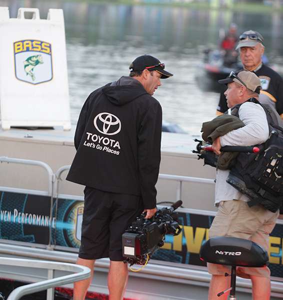 KVD helps his cameraman board his boat.