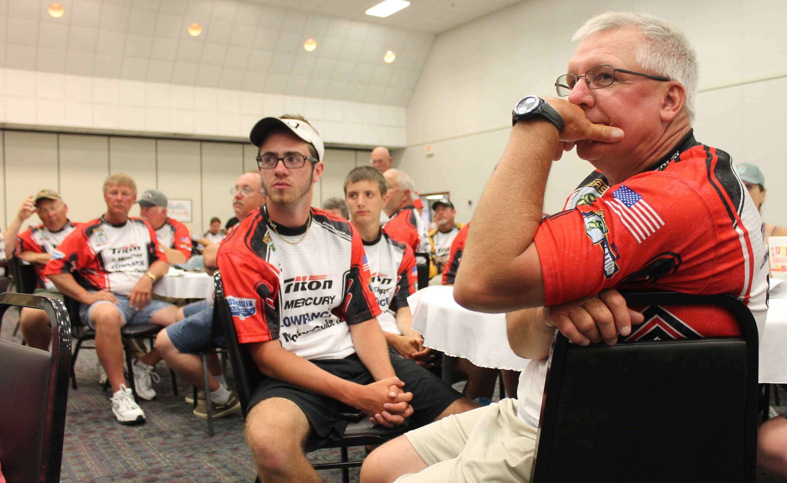 Missouri anglers Gary Soske (foreground) and Bryce Soske (right) listen intently as Stewart covers the tournament rules.
