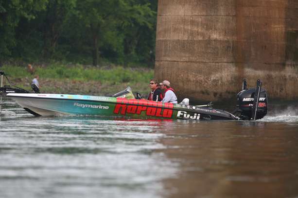 Bernie Schultz idles upstream to find another fishing spot near the dam. 