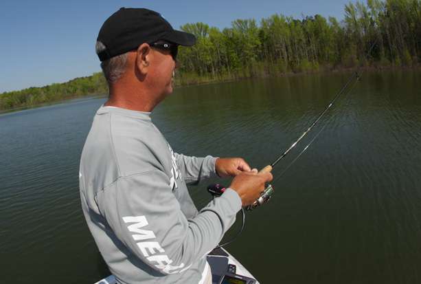 Rook uses a small spinning rig, swimming a crappie jig on the edge of grass to hook up with crappie.
