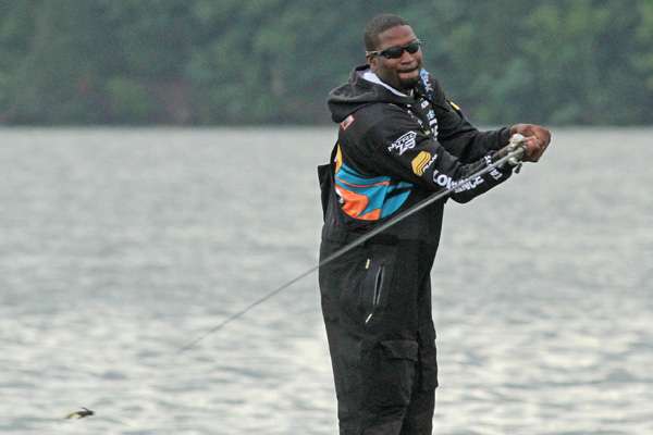 Across the river, Kendall Newson makes a long cast.