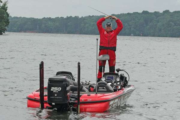 Matt Reed uses sign language to relay how many fish are in his boat.