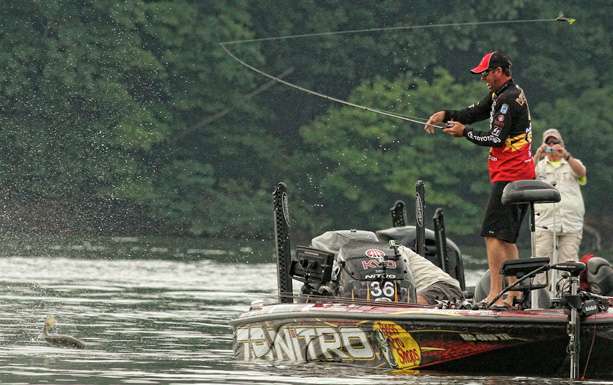 The fish is still in the air as KVD swings his bait toward it.