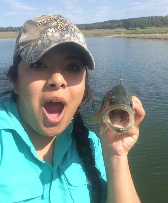 <p>We're not sure if Genny Camacho is mimicking the fish's face or if it's mimicking hers, but this is a classic bass selfie.</p>
