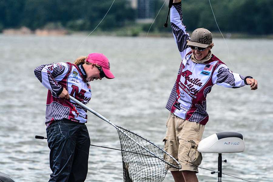 Alex Rigg and Wyatt Armstrong laugh at their fish catch. Wyatt hand-lined in a keeper fish.