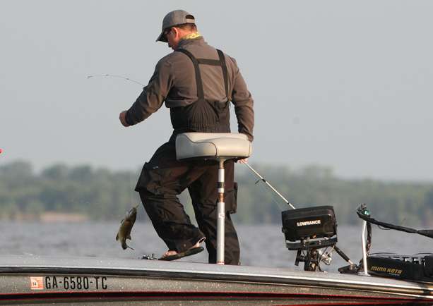 Carroll Blevins swings a smallmouth into the boat. 