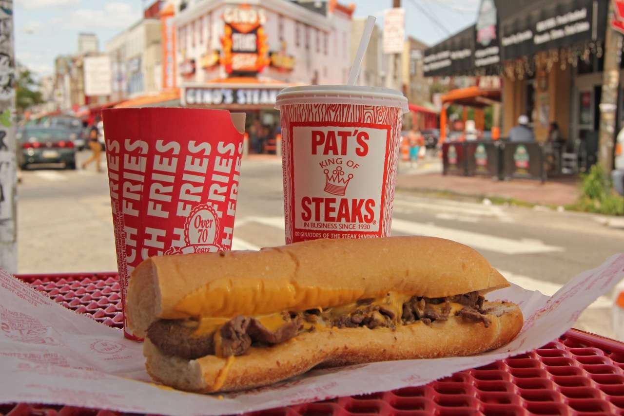 TWO of the many legendary eateries Ike rattled-off when asked where to find a good cheesesteak: 1) Genoâs; 2) Patâs. Interestingly, Patâs and Genoâs compete diagonally across the street from one another, just one long Iaconelli cast apart. 