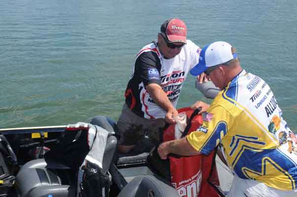 Randy Burch bags his fish with an assist from Ed Schiller.