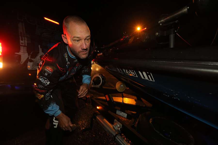 Brent Chapman takes off all of the necessary straps on his boat.