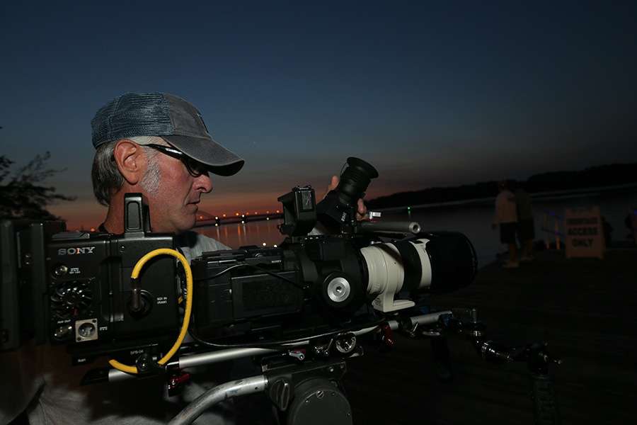 Cameraman Wes Miller checks his equipment prior to takeoff.