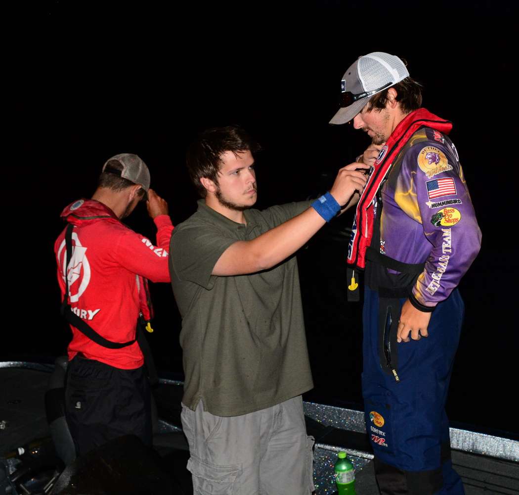 Ben Oliver sets up the mic on Bethel University's Zach Parker. Oliver is part of the ESPN production crew that will be filming the competitors all day on the water.