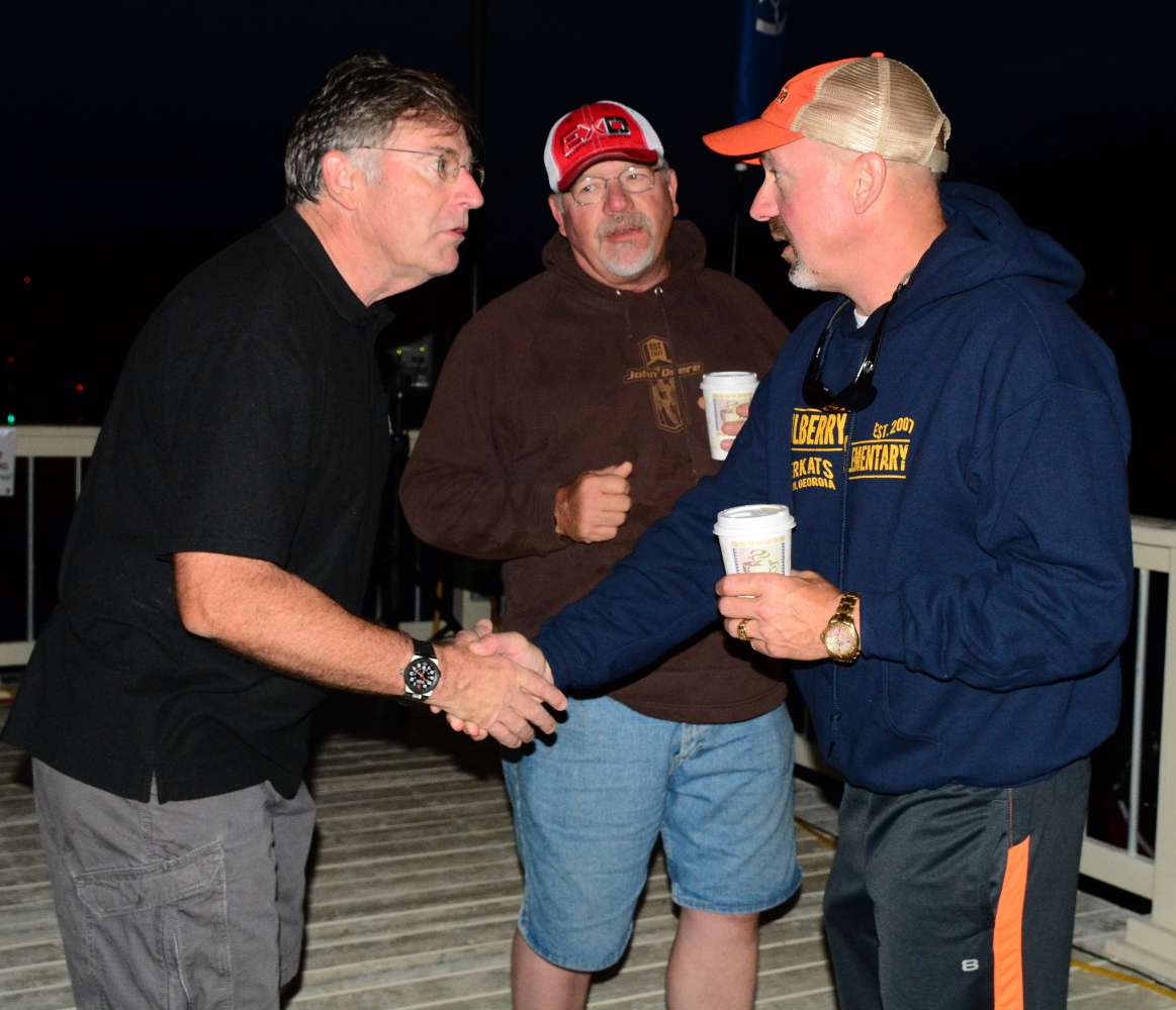 ESPN announcer Tommy Sanders meets with some of the boat drivers who will be taking out camera boats.