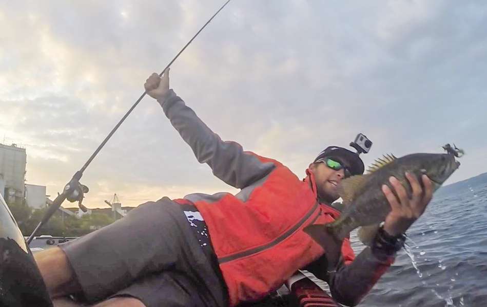 Brandon Palaniuk rolls a solid smallmouth into the boat on his first cast. 