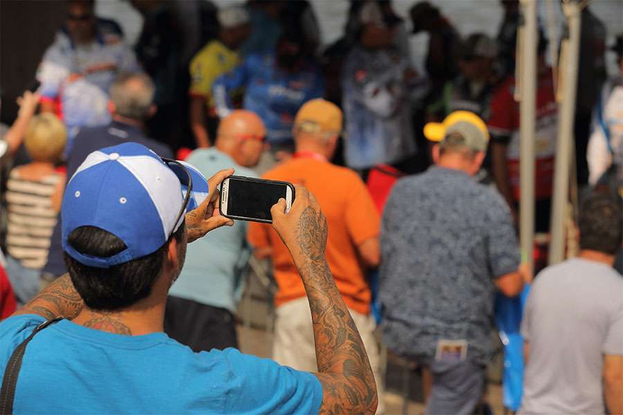A fan shoots some photos of his favorite anglers.