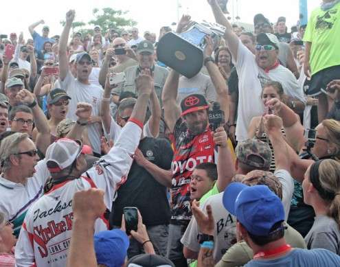 With the crowd cheering, Iaconelli lifts the trophy overhead.