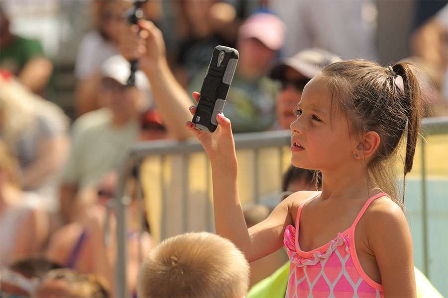 Nevaeh Lowen uses smart phone to shoot her father Bill's weigh-in.