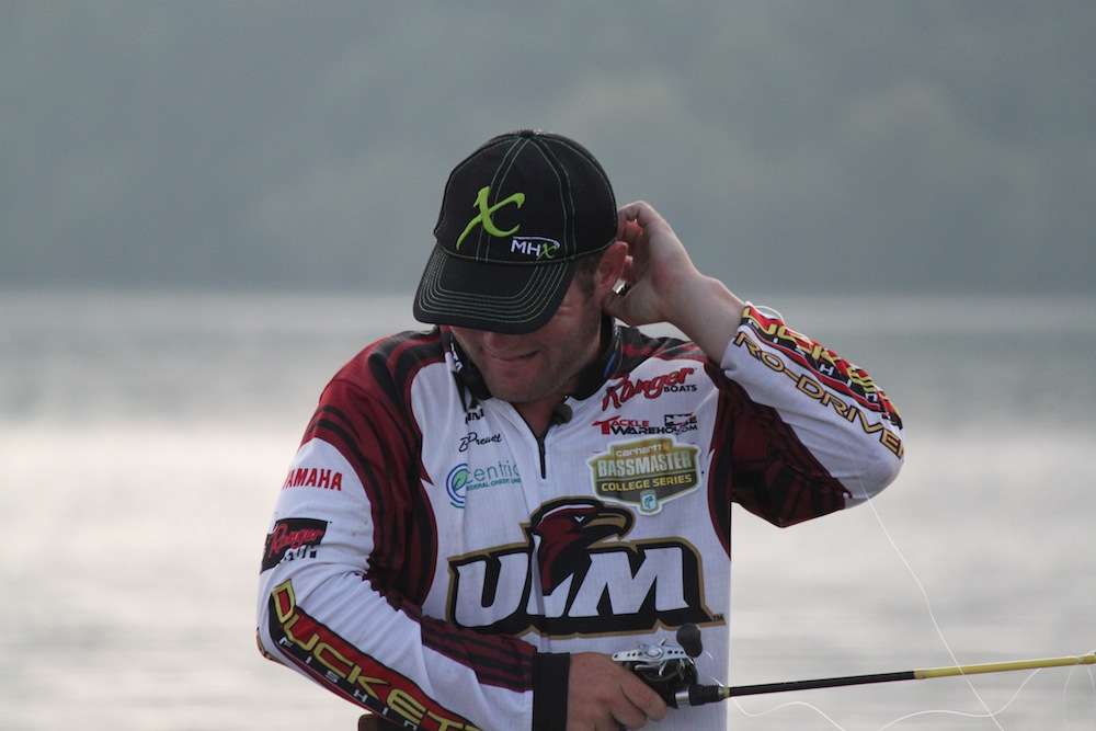 After a fish misses the bait, Preuett hurries to throw back to it and accidentally hooks himself in the back of the head with his topwater. 