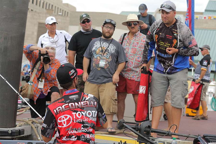 Mike Iaconelli talks to media as he stows his tackle.