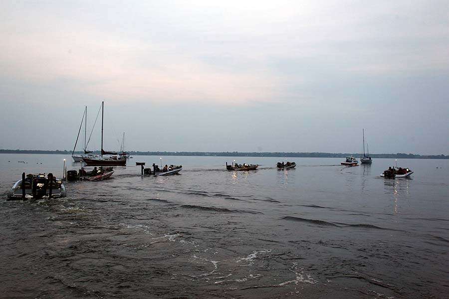 The line of boats idles into the lake, led by TowBoatU.S.