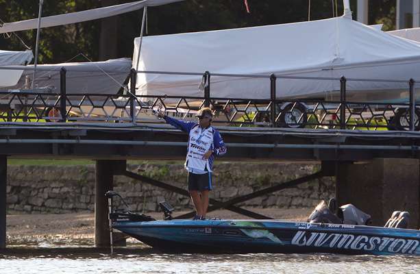 Byron Velvick pitches a bait along a boat dock. 