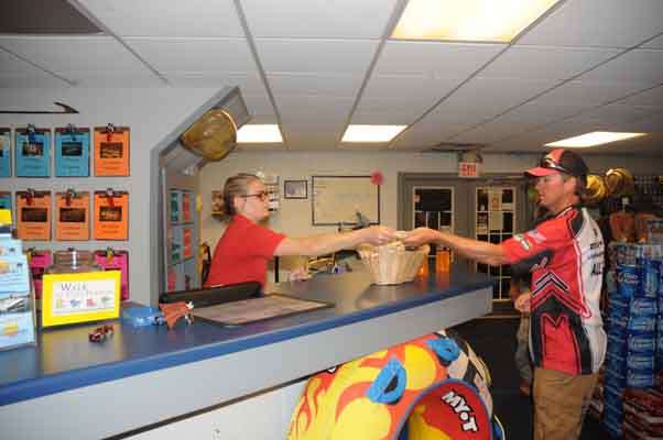 Troy Lee gets some change back from Fourwinds Resort Marina clerk Ally Anderson.