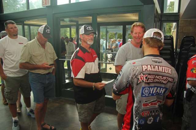 The line into registration was a long one; Palaniuk had lots of fishing licenses to look at. He jokes here with David Lloyd and William Jones of Florida.