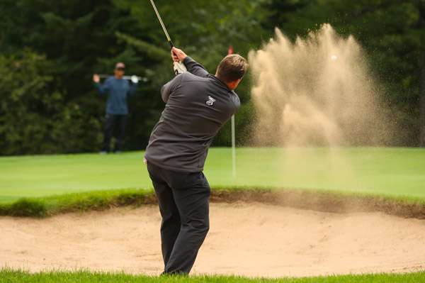 Sending a burst of sand and the ball...