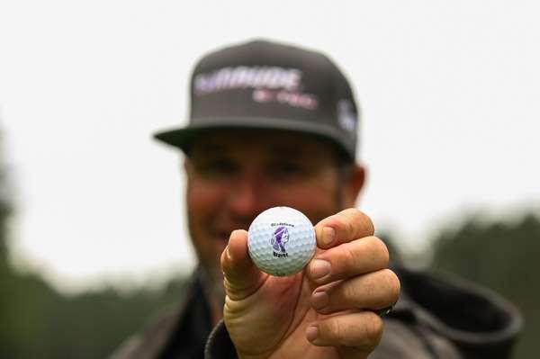Hite shows off the Gladstone Braves golf ball he found on the course.