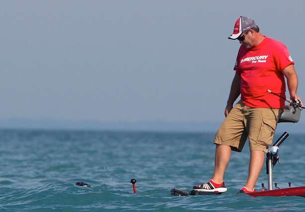 Todd Steele attempts to keep an eye on his electronics as the bow of his boat dips under water. 