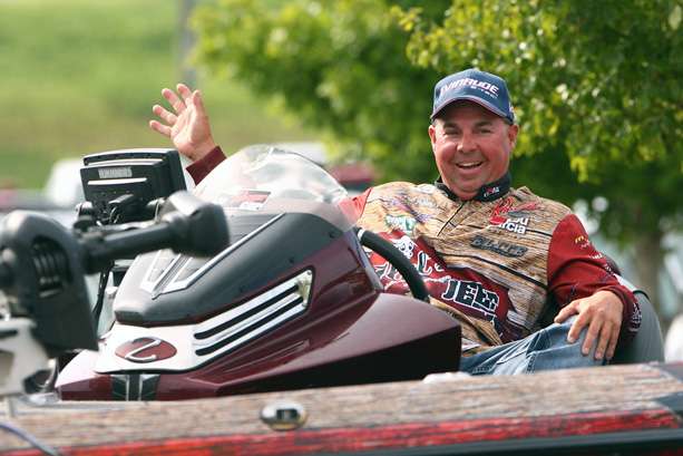 Mark Goines waves to spectators as he is pulled to the stage. 